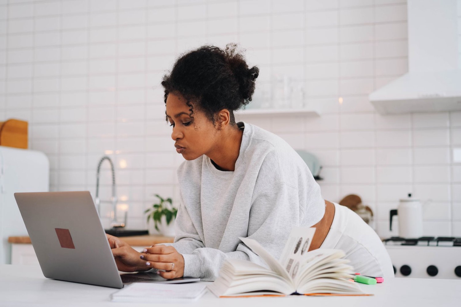 Agent learning on a laptop at a kitchen table