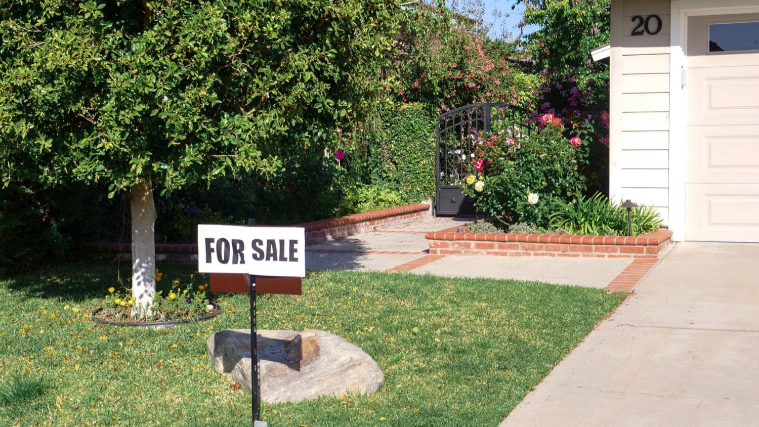 For sale sign in front of a house